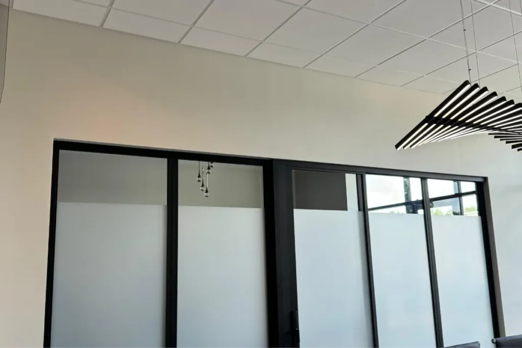 Frosted commercial window film installed on office glass doors for privacy
